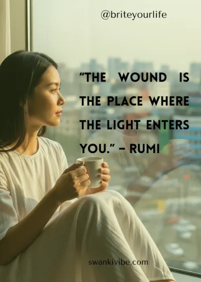 Person reflecting on heartbreak by a serene window.