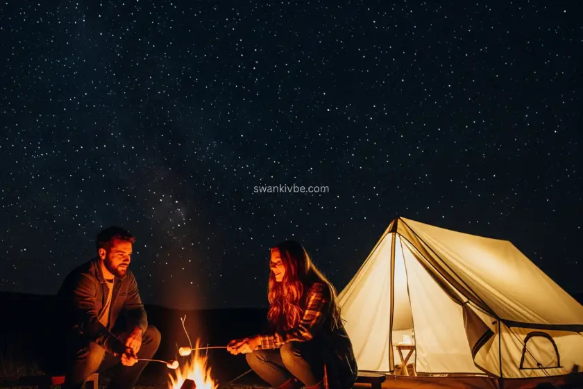  A couple roasting marshmallows by a campfire, with a tent glowing under stars.