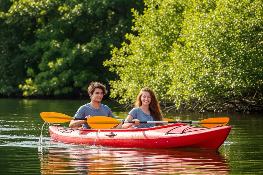  A couple paddling a tandem kayak on a serene lake, surrounded by lush greenery.