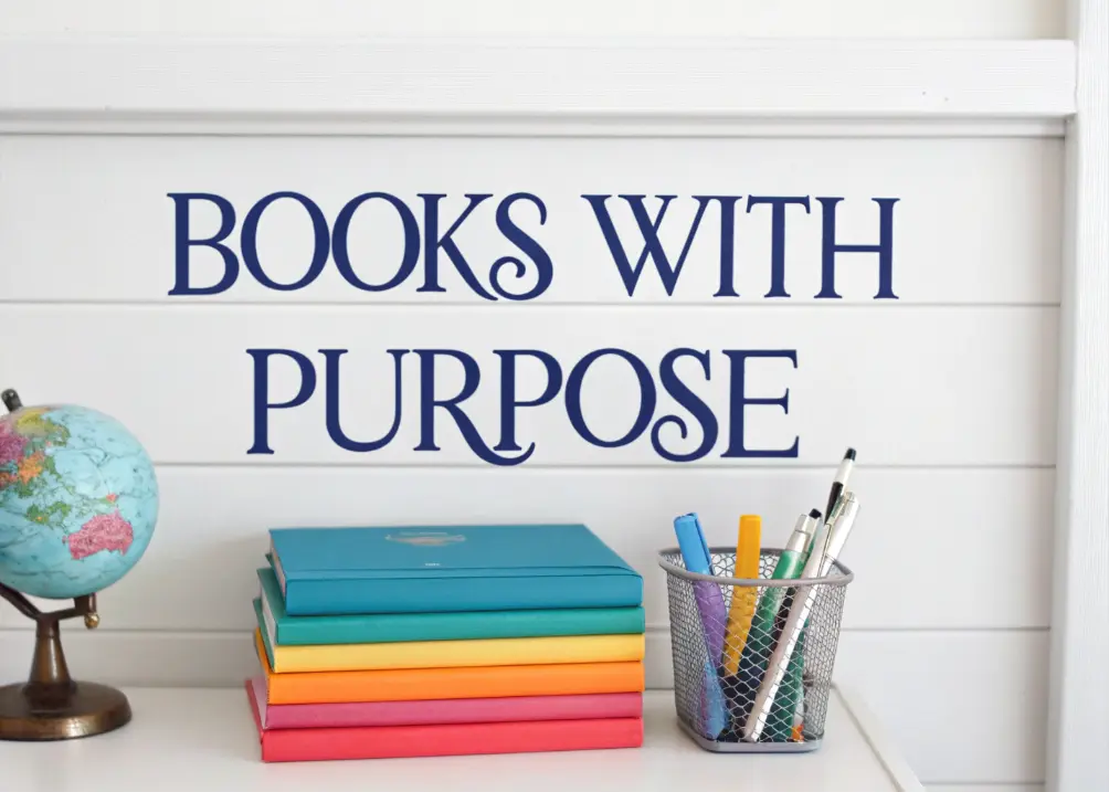 A shelf with a stack of colorful books topped with a small globe, next to a wire organizer holding pens.